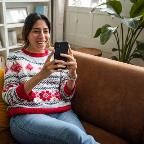 smiling woman looking at phone